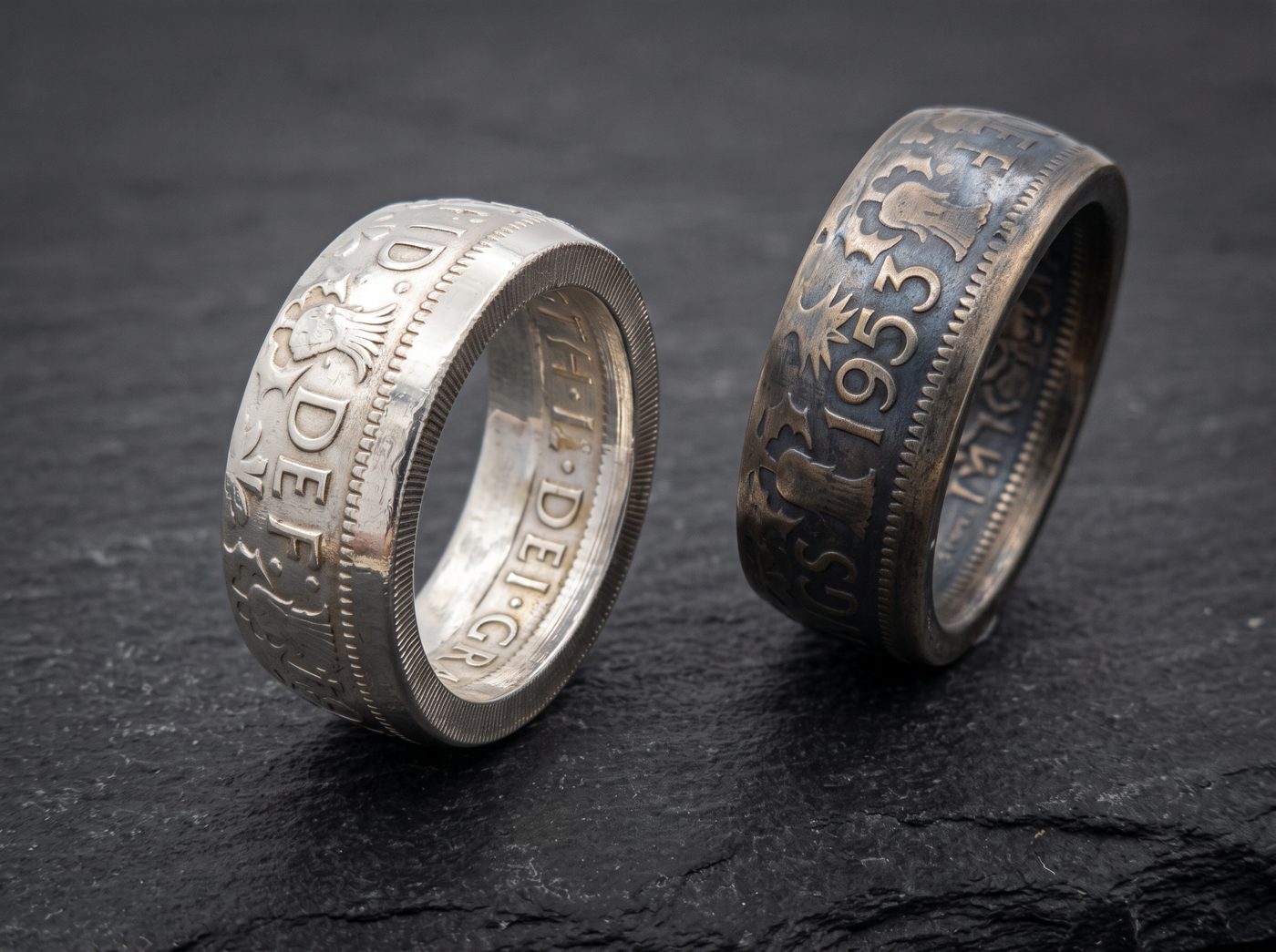 Two finished coin rings on slate